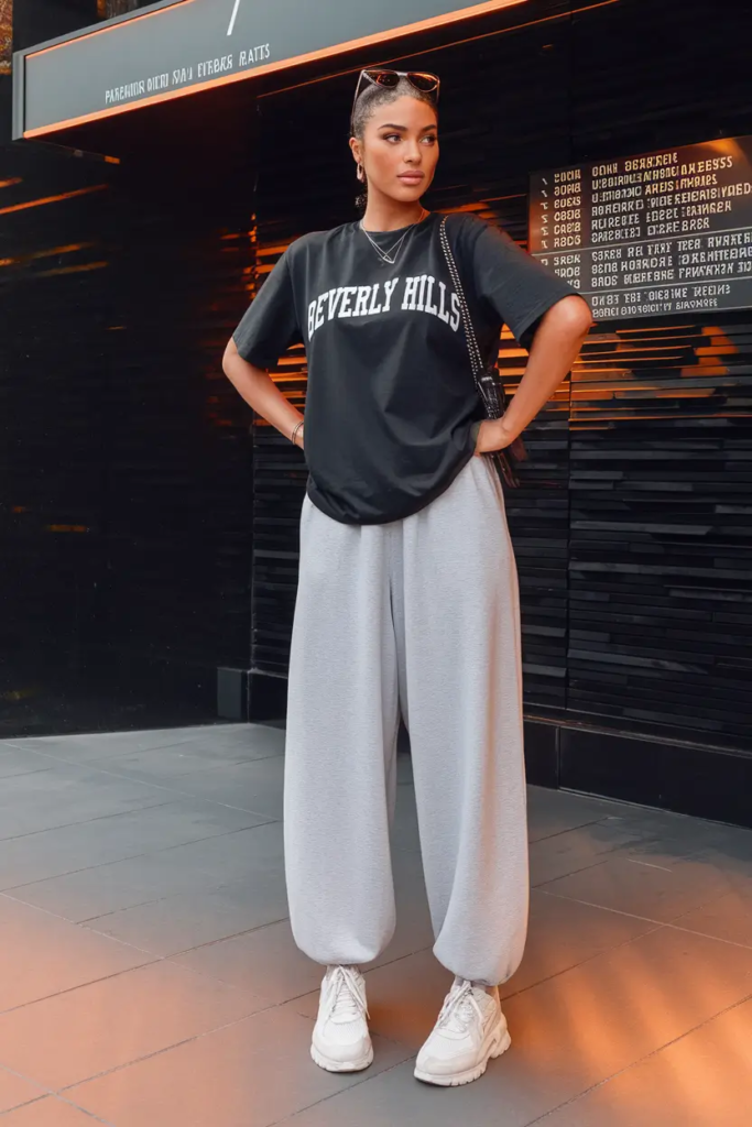 Loose graphic t-shirt with soft grey sweatpants and chunky sneakers styled for a relaxed comfy school outfit