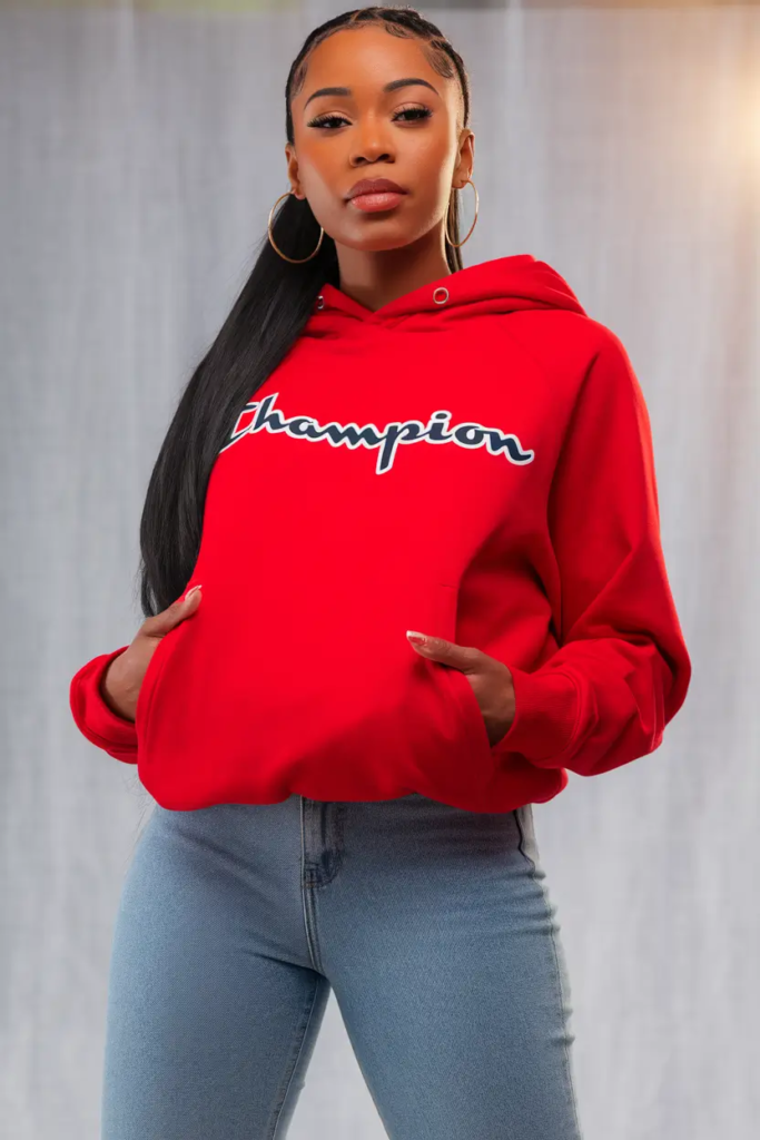 Vibrant red hoodie paired with high-rise blue jeans and white sneakers for a bold yet casual school outfit