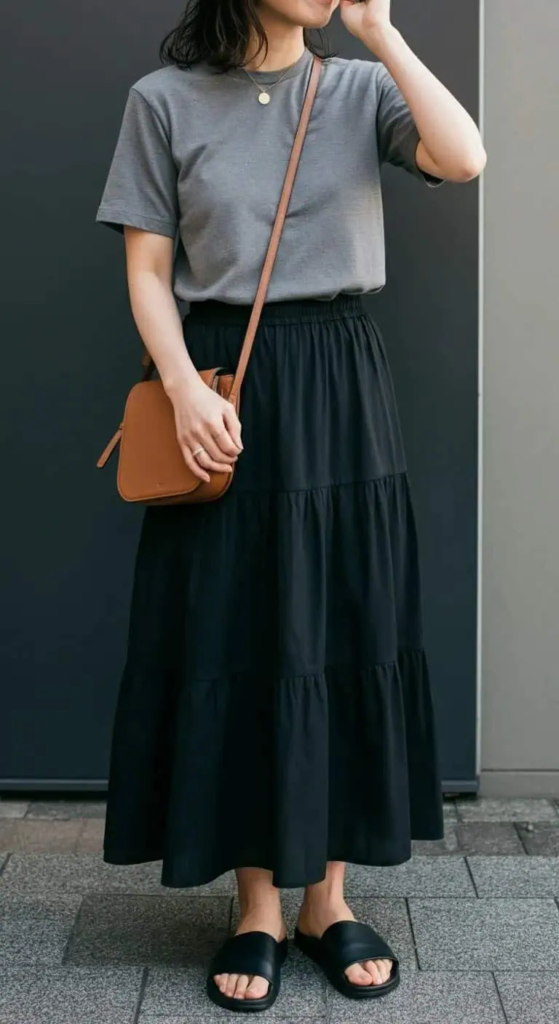 Tiered maxi skirt with gray crew neck tee, leather slide sandals, and crossbody bag casual summer outfit for women