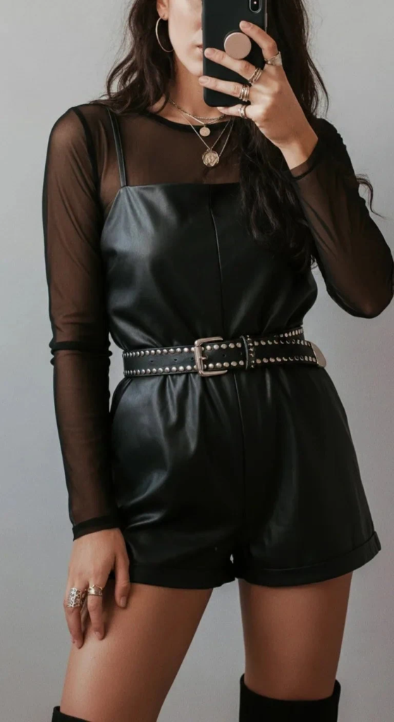Leather romper with mesh sleeves styled for summer concerts featuring edgy, breathable festival-ready fashion.