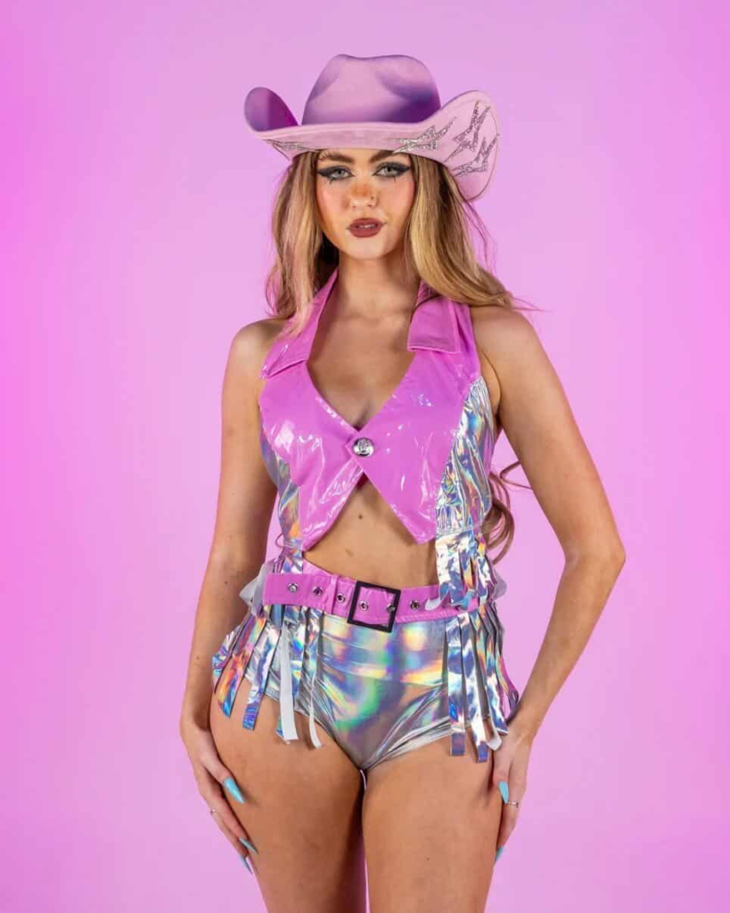 Futuristic holographic hot pants and vinyl crop top styled with glitter cowboy hat for a festival-ready baddie cowgirl outfit.