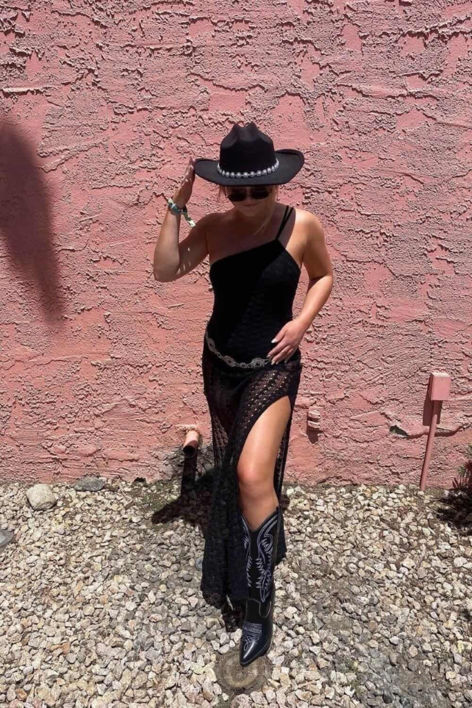 Black lace skirt with one shoulder bodysuit styled with cowboy hat and embroidered boots for an elegant baddie cowgirl outfit.