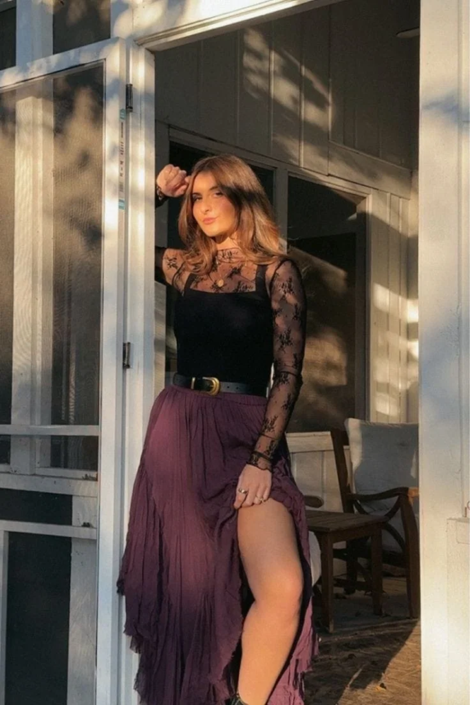 Sheer black lace long sleeve top styled with a flowing burgundy maxi skirt and vintage gold belt for a romantic boho goth outfit