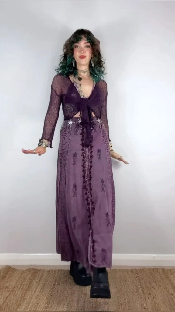 Deep plum wrap top paired with embroidered floor-length skirt and celestial belt for a mystical boho goth outfit