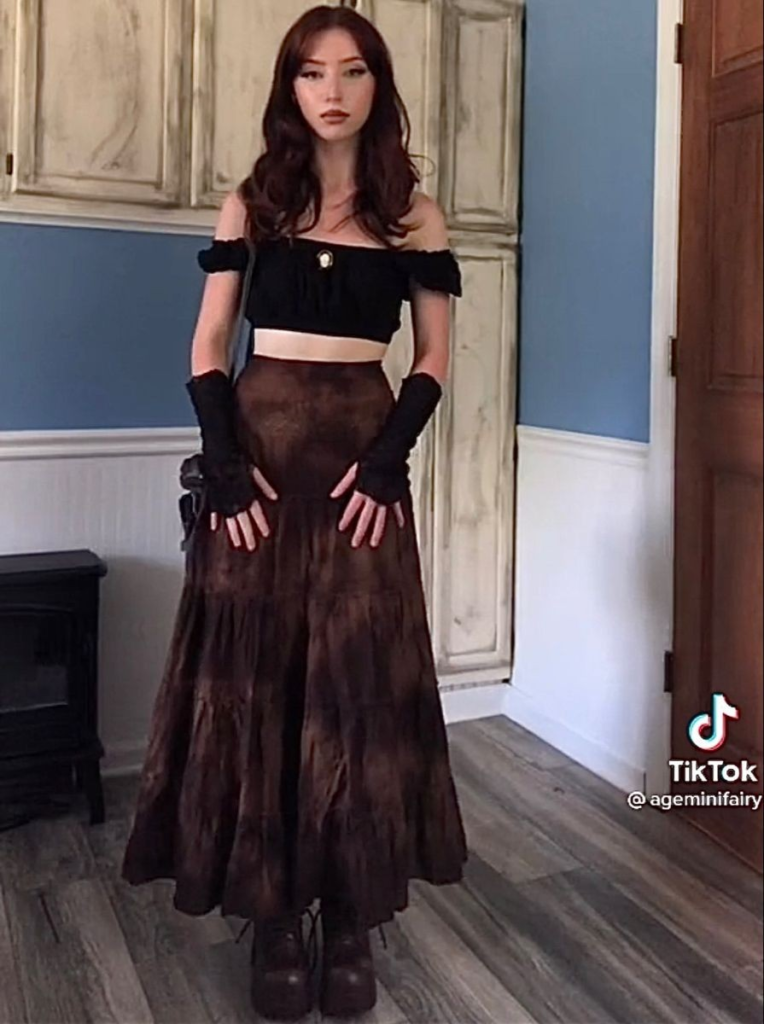 Black off-shoulder velvet crop top paired with flowing chocolate brown midi skirt and long gloves for a moody boho goth look