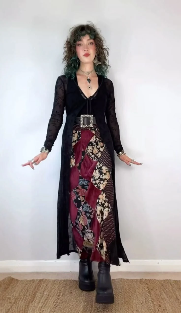Flowing black cardigan layered over burgundy floral and geometric print dress with black platform boots in a boho goth outfit