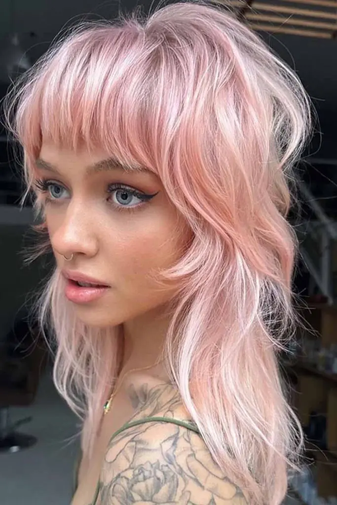 Medium Shaggy Wolf Cut With Choppy Bangs on Pastel Pink Hair

